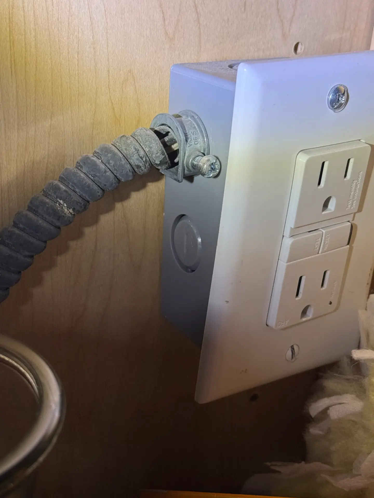 Exposed electrical wiring beneath kitchen sink