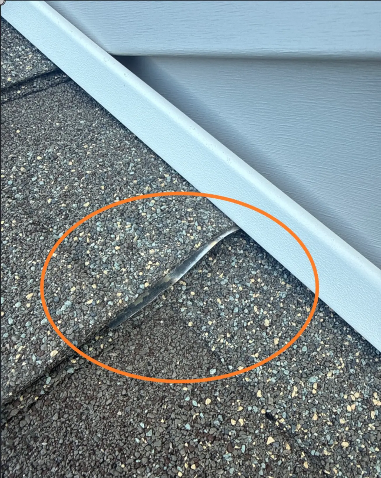 Step flashing extending out from under roof shingle