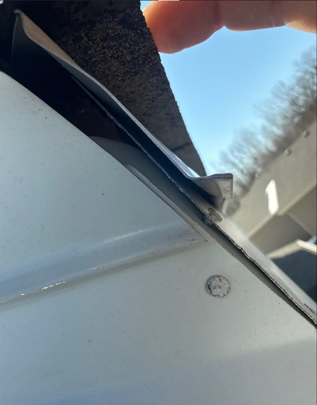 Fascia metal corner not fully enclosed, exposing underlying wood framing