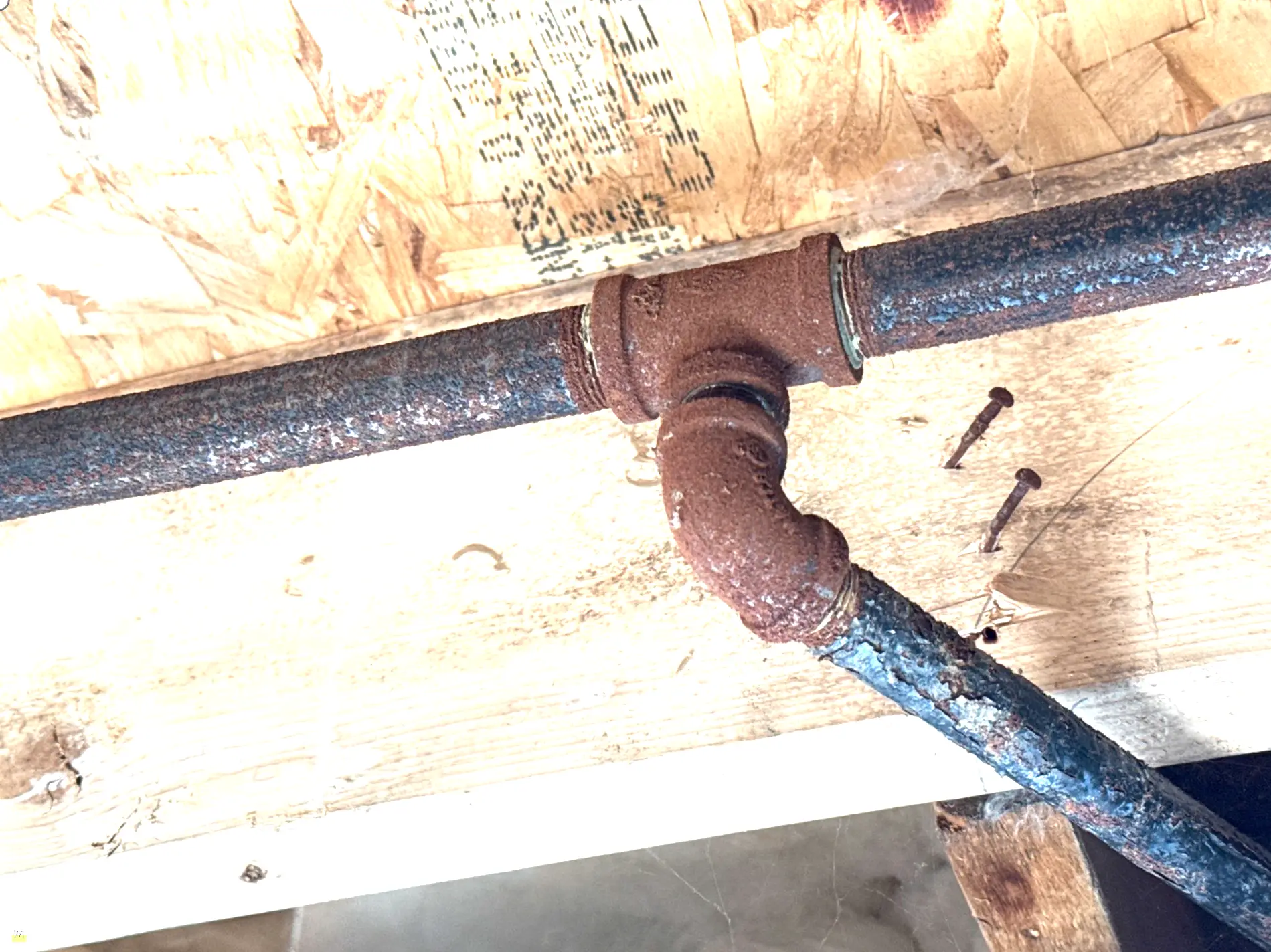 Black iron gas pipe with heavy corrosion and flaking rust scale